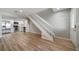 Open living space with modern flooring, staircase, and a view of the adjacent kitchen area at 1697 S Cole St # B5, Lakewood, CO 80228