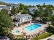 Aerial view of community pool and hot tub surrounded by lounge chairs and lush landscaping at 1697 S Cole St # B5, Lakewood, CO 80228
