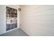Covered porch features concrete flooring, off-white siding, and white storm door at 1697 S Cole St # B5, Lakewood, CO 80228
