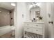 Bathroom with white vanity with a black faucet and a gray-tiled shower/tub combo at 4068 S Atchison Way # 103, Aurora, CO 80014