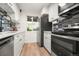 An updated kitchen featuring new stainless steel appliances, white cabinets, and butcher block counters at 4068 S Atchison Way # 103, Aurora, CO 80014