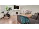 A modern living room with a cozy fireplace, a TV, Peloton, and a dining table at 4068 S Atchison Way # 103, Aurora, CO 80014