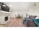 Bright living room with a decorative fireplace, dining area, a sliding glass door, and hardwood floors at 4068 S Atchison Way # 103, Aurora, CO 80014