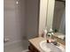 Well-lit bathroom with white tiles in the shower and a functional vanity area at 15690 E Mexico Ave, Aurora, CO 80017