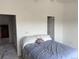 Bright and airy bedroom featuring neutral walls, carpeted floors, and access to adjacent rooms at 15690 E Mexico Ave, Aurora, CO 80017