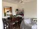 Open concept dining area featuring a ceiling fan and view of the kitchen at 15690 E Mexico Ave, Aurora, CO 80017