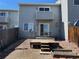 Exterior view showing a home with a private deck, sliding glass door, and small backyard at 15690 E Mexico Ave, Aurora, CO 80017