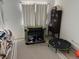 Neutral toned living room featuring a mini trampoline, antique cabinet, and dog crate at 15690 E Mexico Ave, Aurora, CO 80017