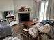 Inviting living room with a stone fireplace, a television, and a decorative quilt at 15690 E Mexico Ave, Aurora, CO 80017
