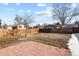Large backyard featuring a brick patio and wood fence, offering privacy and space for outdoor activities at 104 Stuart St, Denver, CO 80219