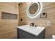 Stylish bathroom featuring a lighted mirror, modern vanity, and patterned tile floor at 104 Stuart St, Denver, CO 80219