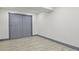 Minimalist bedroom design with gray trim and bi-fold closet, offering a clean and modern look at 104 Stuart St, Denver, CO 80219
