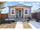 Charming home featuring a bright blue front door and natural wood accents at 104 Stuart St, Denver, CO 80219