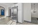 Open floor plan with stainless refrigerator, white cabinets, and luxury vinyl floors at 104 Stuart St, Denver, CO 80219