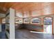 Open sunroom design with wood paneled walls and ceilings and built in shelving for extra storage at 104 Stuart St, Denver, CO 80219