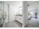 Bright, updated bathroom featuring a double sink vanity and separate shower and bedroom areas at 1673 S Fulton St, Aurora, CO 80247