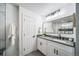 Updated bathroom with white vanity, modern fixtures, and a view of the shower at 1673 S Fulton St, Aurora, CO 80247
