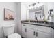 Chic bathroom featuring modern fixtures, vanity with stone counter, and decorative mirror at 1673 S Fulton St, Aurora, CO 80247