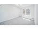 Bright, neutral bedroom with soft carpet and a large window at 1673 S Fulton St, Aurora, CO 80247