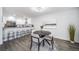 Cozy dining area featuring a round table, bar seating and modern decor in an open space at 1673 S Fulton St, Aurora, CO 80247