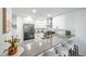 Modern kitchen with white cabinets, stainless steel appliances, and a spacious gray countertop with bar stool seating at 1673 S Fulton St, Aurora, CO 80247