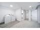 Bright laundry room with white washer and dryer with access to a bathroom and other rooms at 1673 S Fulton St, Aurora, CO 80247