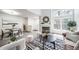 Open layout showcasing dining and living areas with windows, fireplace, and contemporary decor at 1673 S Fulton St, Aurora, CO 80247
