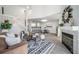 Open-concept living space flows into a modern kitchen and dining area with cozy fireplace at 1673 S Fulton St, Aurora, CO 80247