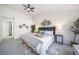 Inviting primary bedroom with a plush bed, decorative wall art, ceiling fan, and ample natural light at 1673 S Fulton St, Aurora, CO 80247
