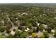 Expansive aerial view of a neighborhood showcasing lush greenery, mature trees, and a mix of residential properties at 4121 S Cherry St, Cherry Hills Village, CO 80113