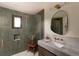 Modern bathroom featuring stylish tile, glass shower, and marble countertop at 4121 S Cherry St, Cherry Hills Village, CO 80113