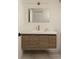Bathroom sink with wood cabinet, white countertop, and gold faucet fixture at 4121 S Cherry St, Cherry Hills Village, CO 80113