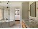 Bright bathroom with a soaking tub, glass shower, dual sinks, and a walk-in closet at 4121 S Cherry St, Cherry Hills Village, CO 80113