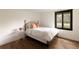 Bedroom with hardwood floors, black trim windows, and a minimalist metal bed frame at 4121 S Cherry St, Cherry Hills Village, CO 80113