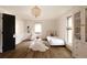 Bright bedroom with hardwood floors, decorative light fixture, and a white daybed at 4121 S Cherry St, Cherry Hills Village, CO 80113