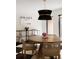 Chic dining room with a round table, rattan chairs, and modern light fixture at 4121 S Cherry St, Cherry Hills Village, CO 80113