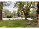 A lush front yard with mature trees, green grass, and beautiful landscaping adds to the home's curb appeal at 4121 S Cherry St, Cherry Hills Village, CO 80113
