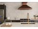 Bright kitchen boasts a large island with elegant countertops, stainless steel appliances, and a copper hood at 4121 S Cherry St, Cherry Hills Village, CO 80113