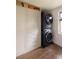Efficient laundry room with stacked washer/dryer and built-in storage at 4121 S Cherry St, Cherry Hills Village, CO 80113