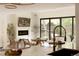 Bright living room featuring a fireplace, outdoor views and sliding glass door to backyard at 4121 S Cherry St, Cherry Hills Village, CO 80113