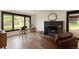 Inviting living room featuring hardwood floors, a fireplace, and large windows at 4121 S Cherry St, Cherry Hills Village, CO 80113