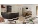 Open-concept living room with dark kitchen island, black and white checkered floors, and a dining area at 4121 S Cherry St, Cherry Hills Village, CO 80113