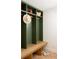 Cozy mud room with custom green lockers, wooden bench, and convenient storage at 4121 S Cherry St, Cherry Hills Village, CO 80113