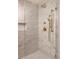 Shower with marble tile, glass enclosure, and a gold shower head and fixtures at 4121 S Cherry St, Cherry Hills Village, CO 80113