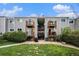Apartment building with balconies, green lawn, bushes, and an American flag flying at 16359 W 10Th Ave # Yy3, Golden, CO 80401