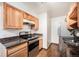 Kitchen featuring wood cabinets, stainless steel appliances, and dark counters at 16359 W 10Th Ave # Yy3, Golden, CO 80401