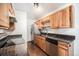 Kitchen with wood cabinets, stainless steel appliances, and dark countertops at 16359 W 10Th Ave # Yy3, Golden, CO 80401