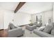 Staged living room with neutral tones, hardwood floors, and an exposed wood beam on the ceiling at 16359 W 10Th Ave # Yy3, Golden, CO 80401