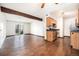 Open-concept living area with dark hardwood floors, a kitchen, and a sliding glass door to a balcony at 16359 W 10Th Ave # Yy3, Golden, CO 80401
