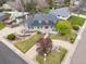 Stunning aerial view of a home with lush landscaping, a welcoming front porch, and a vibrant red front door at 5440 W Hinsdale Ave, Littleton, CO 80128